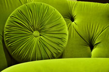 Green velvet  fabric couch and pillow