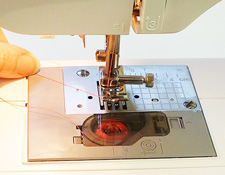 holding upper thread while threading a sewing machine
