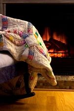 cozy quilt by fireplace